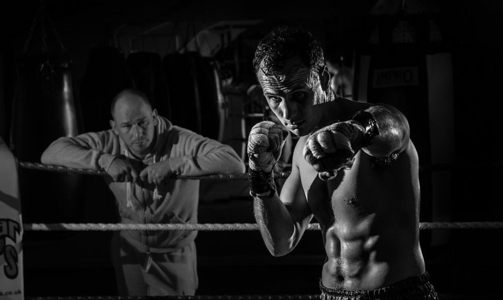 man shadowboxing in the ring