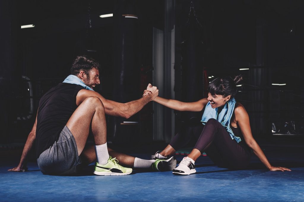 couple sitting in gym after workout