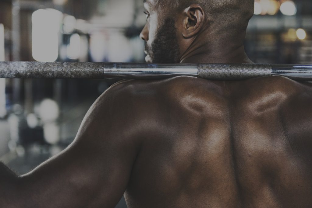 man with barbell on his back