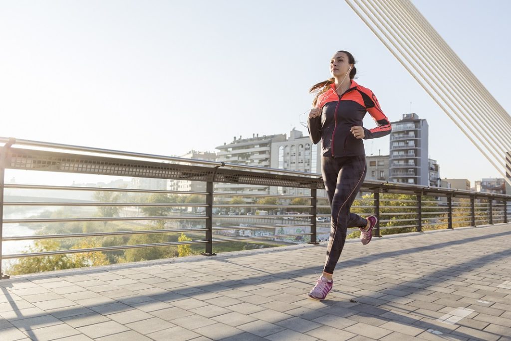 woman running over bridge
