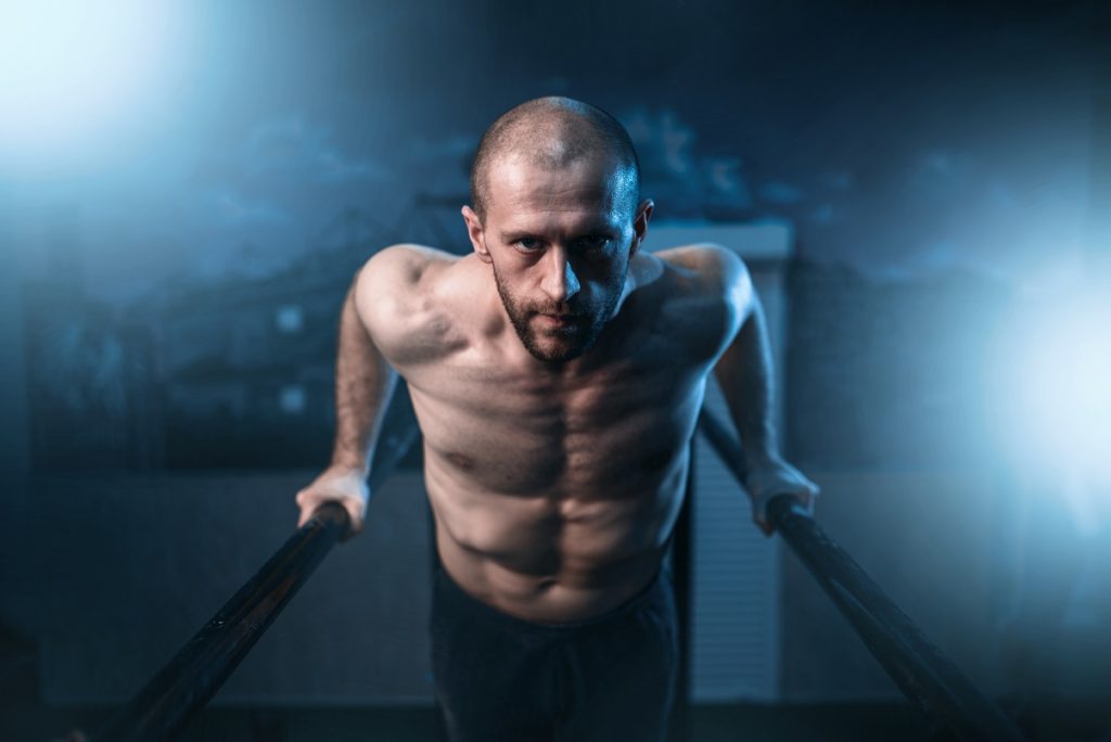 man performing parallel bar dips workout