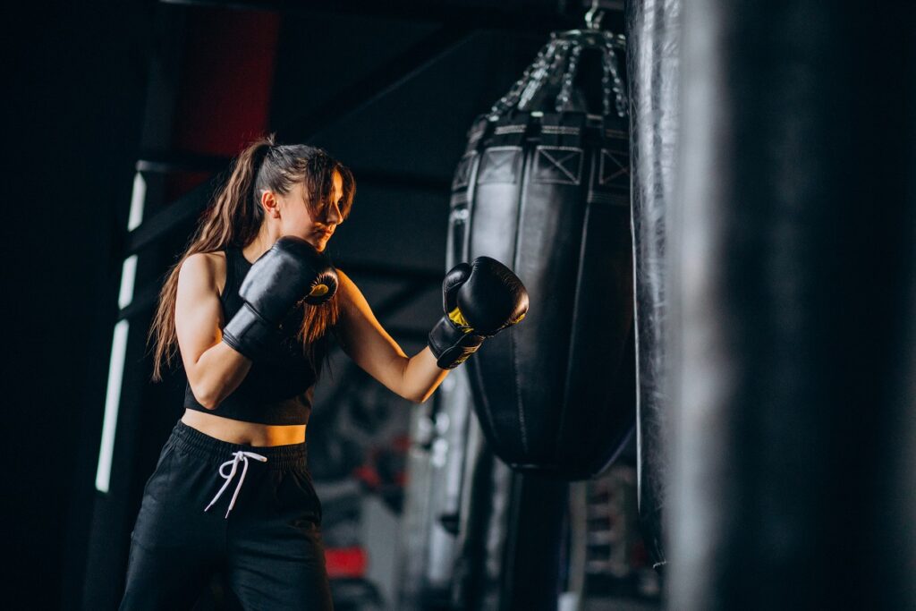 woman boxing on punch bag